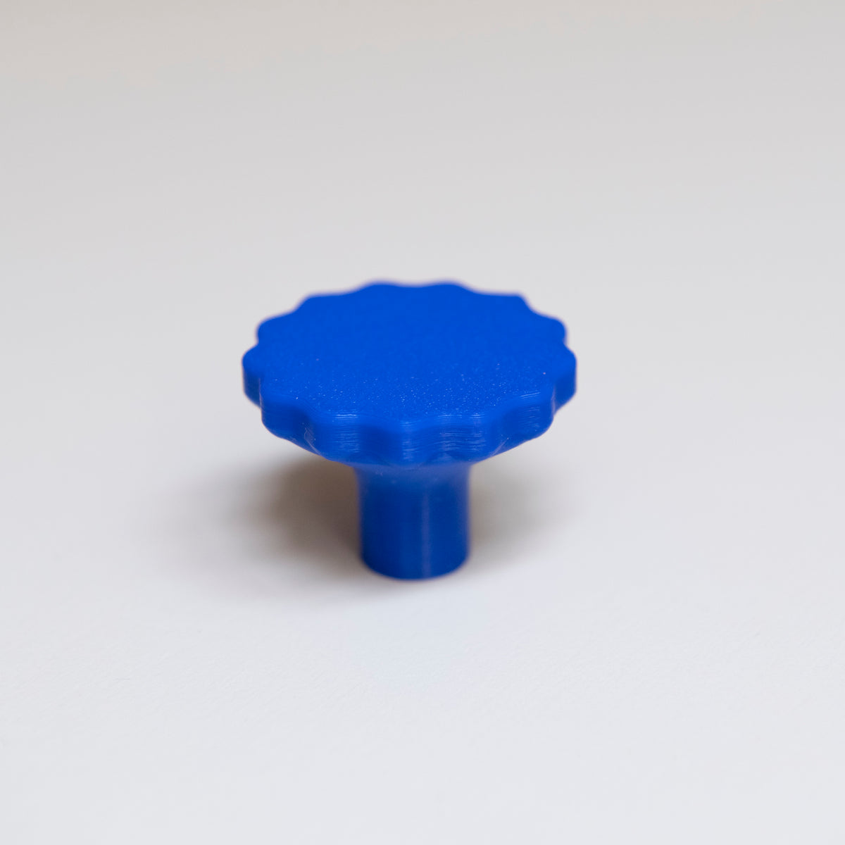 Bouton de meuble Manège couleur bleu outremer, créé en collaboration par Polycoco et Studio Couleur, en bioplastique éco-responsable.