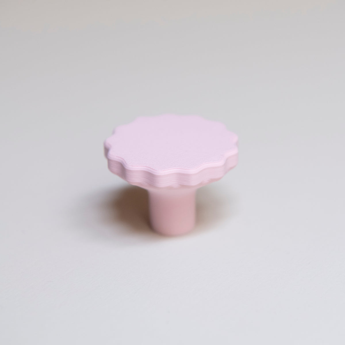 Bouton de meuble Manège couleur rose pâle, créé en collaboration par Polycoco et Studio Couleur, en bioplastique éco-responsable.