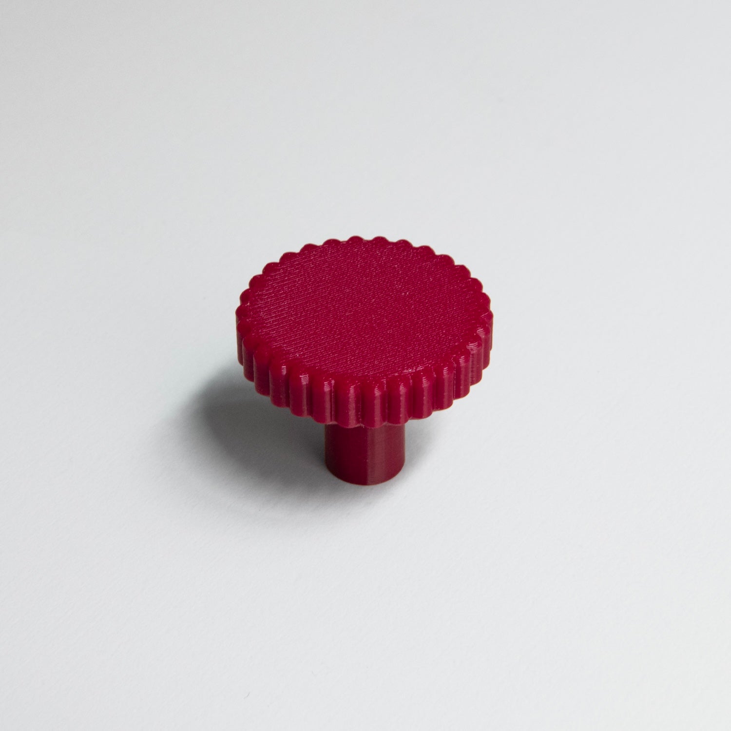 Bouton de meuble Biscuit couleur rouge, créé en collaboration entre Studio Couleur et Polycoco, en bioplastique éco-responsable. 