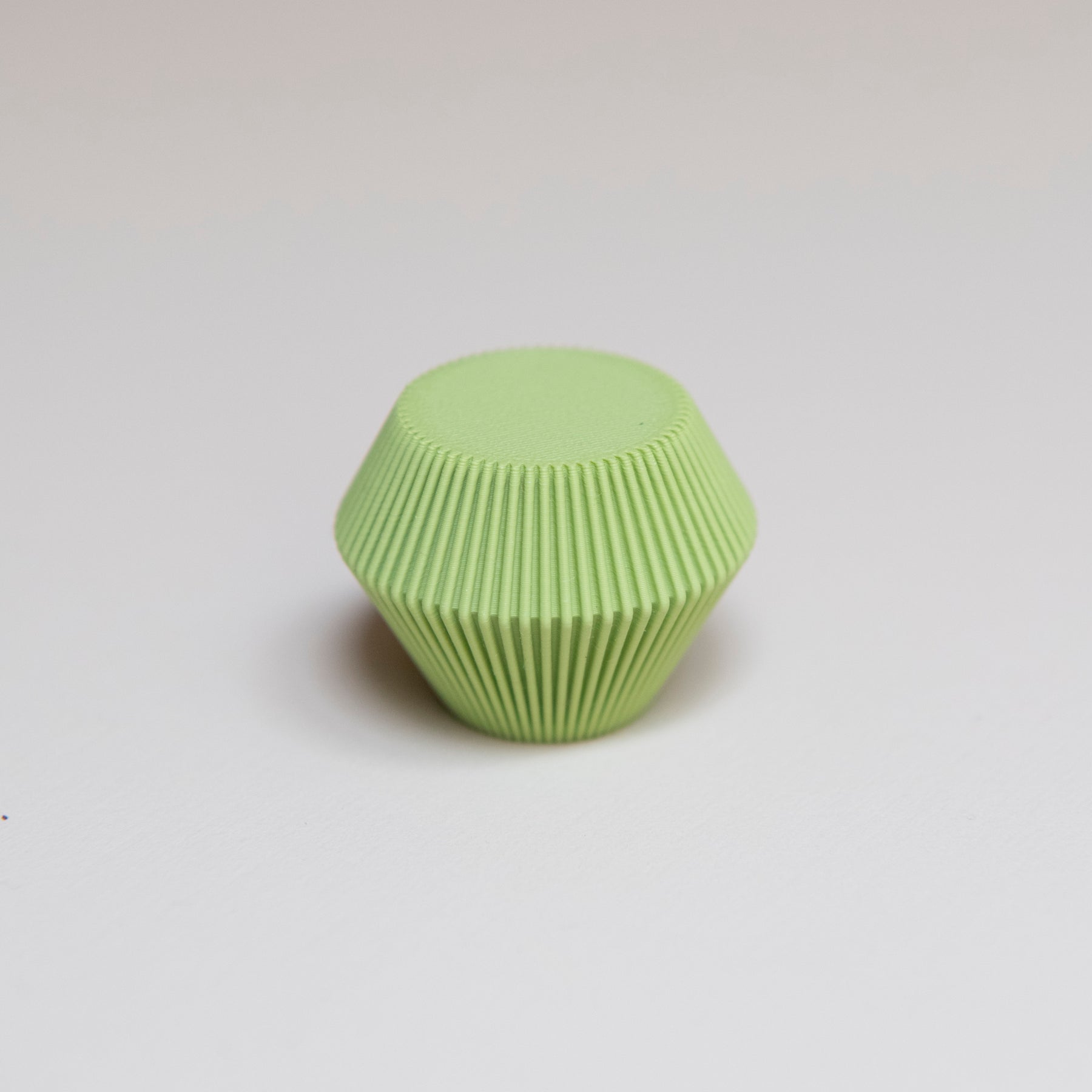 Bouton de meuble Facette couleur vert pistache créé en collaboration entre Studio Couleur et Polycoco, en bioplastique éco-responsable. 